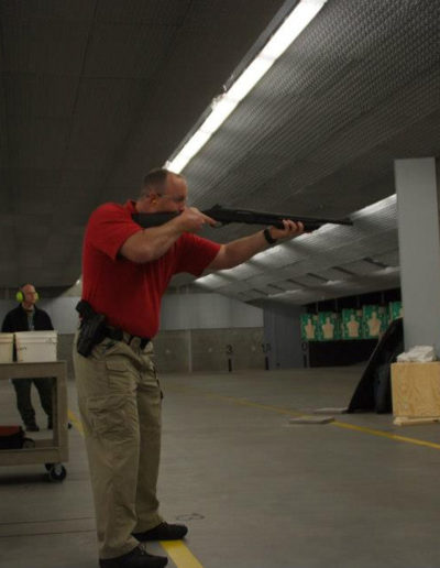 Red Man holding a shotgun